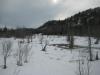 A snowy, swampy Eagle River below the cliffs