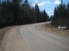 Curving road still covered in winter sands